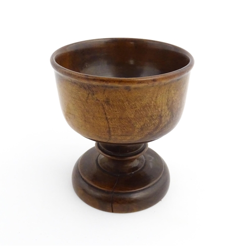 1119 - Treen : A 19thC treen pedestal master salt of squat goblet form with a bladed knopped column on a ci... 