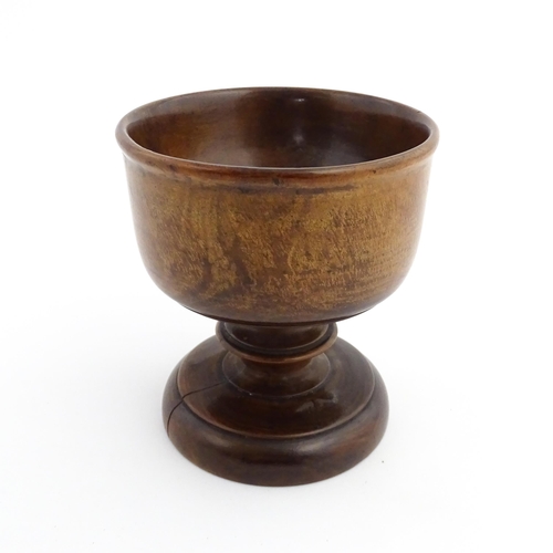 1119 - Treen : A 19thC treen pedestal master salt of squat goblet form with a bladed knopped column on a ci... 