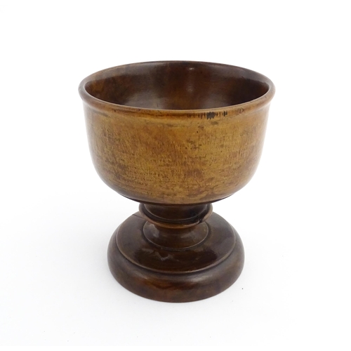 1119 - Treen : A 19thC treen pedestal master salt of squat goblet form with a bladed knopped column on a ci... 