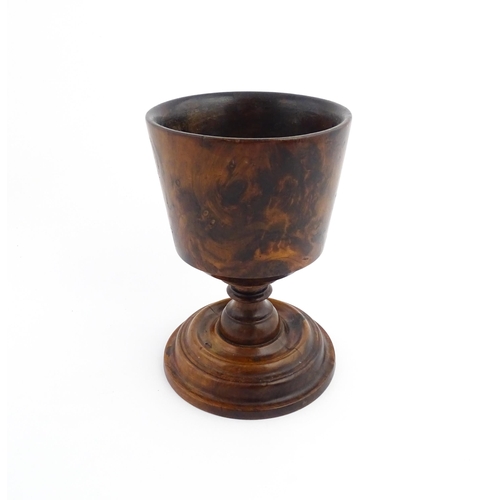 1122 - Treen : An 18thC wooden loving cup with bladed knopped column. Approx. 8 1/2