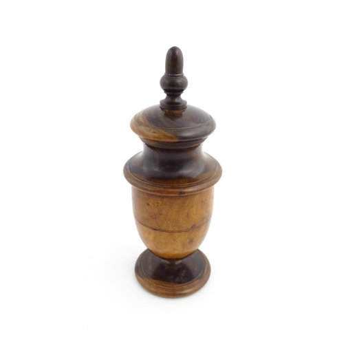 1123 - Treen : An 18thC lignum vitae spice / coffee grinder of urn form, the iron spigot concealed by an ac... 