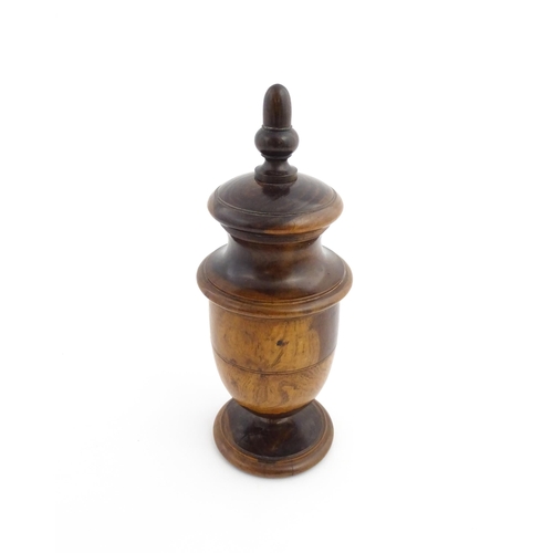 1123 - Treen : An 18thC lignum vitae spice / coffee grinder of urn form, the iron spigot concealed by an ac... 