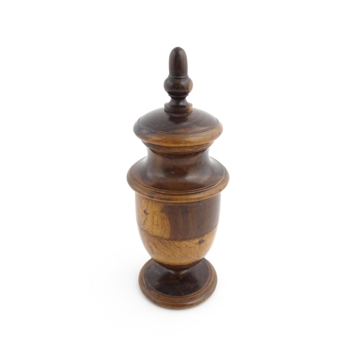 1123 - Treen : An 18thC lignum vitae spice / coffee grinder of urn form, the iron spigot concealed by an ac... 