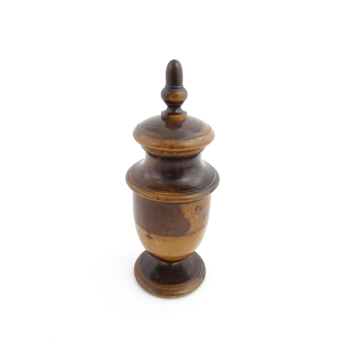 1123 - Treen : An 18thC lignum vitae spice / coffee grinder of urn form, the iron spigot concealed by an ac... 