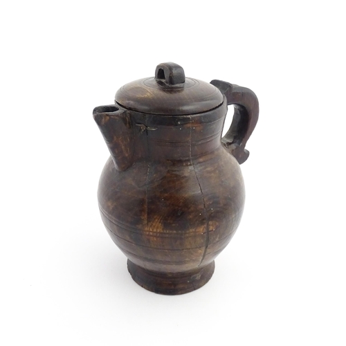 1124 - Treen : A 19thC oak lidded jug. Approx. 8