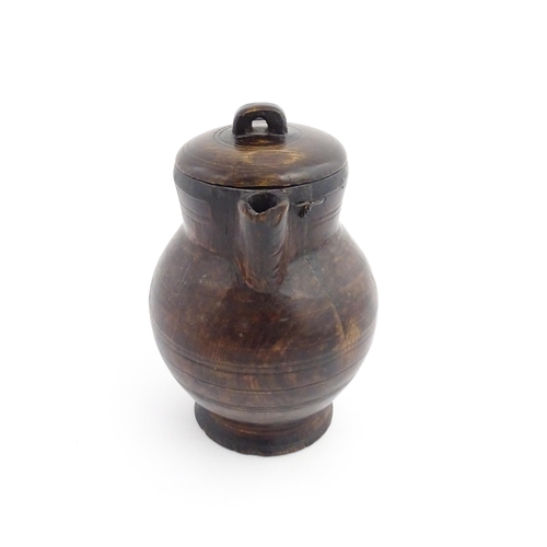 1124 - Treen : A 19thC oak lidded jug. Approx. 8