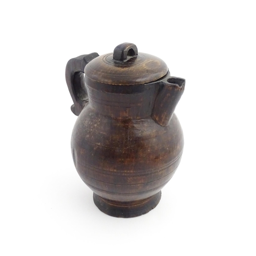 1124 - Treen : A 19thC oak lidded jug. Approx. 8