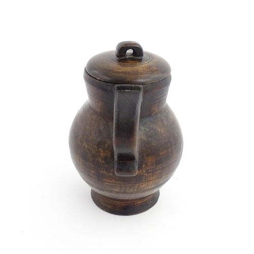 1124 - Treen : A 19thC oak lidded jug. Approx. 8