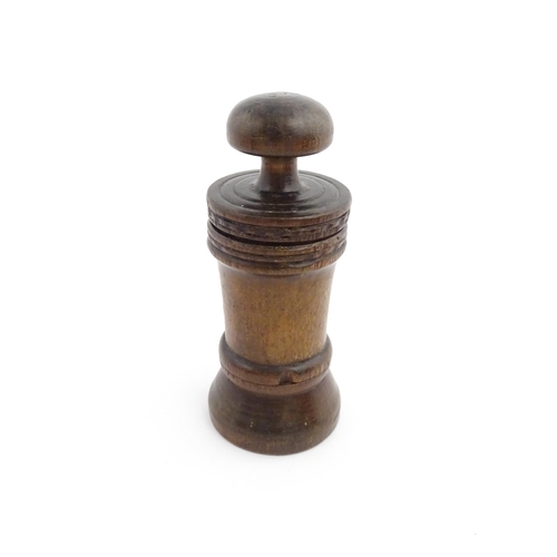 1127 - Treen : An 18thC three sectional turned nutmeg / spice with banded decoration. Approx. 7