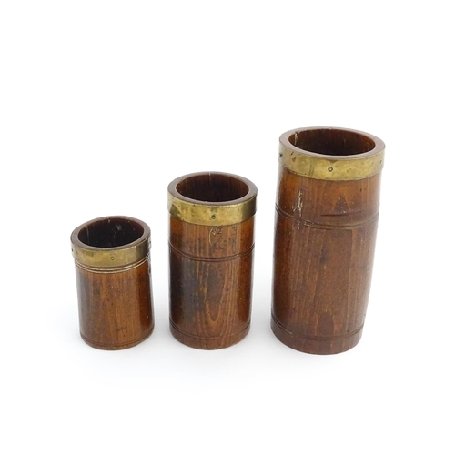 1128 - Treen : Three graduated Victorian and later oak dry measures with brass rims, comprising Quart, Pint... 