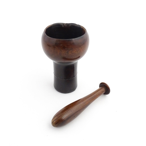 1129 - Treen : A 19thC lignum vitae snuff pestle and mortar of tapering form. Mortar approx. 4 1/4