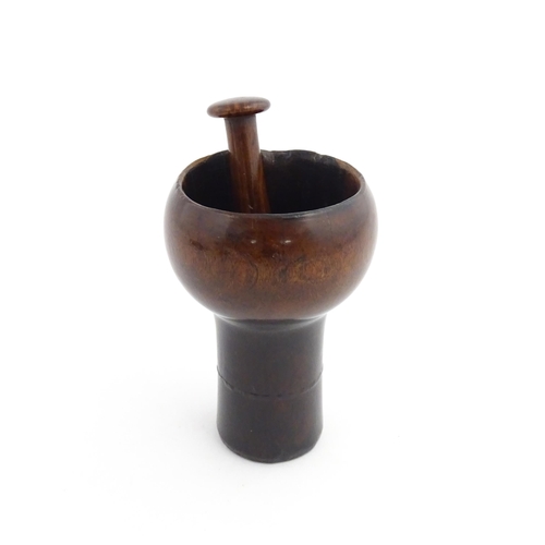 1129 - Treen : A 19thC lignum vitae snuff pestle and mortar of tapering form. Mortar approx. 4 1/4