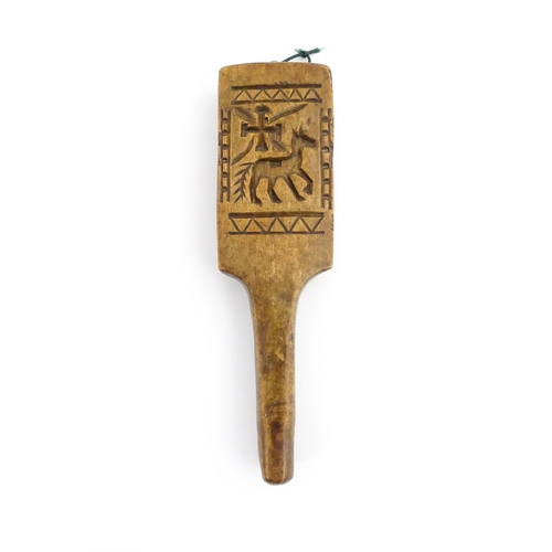 1131 - Treen : A 19thC carved wooden gingerbread biscuit mould of paddle form with horse and cross decorati... 