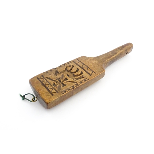 1131 - Treen : A 19thC carved wooden gingerbread biscuit mould of paddle form with horse and cross decorati... 