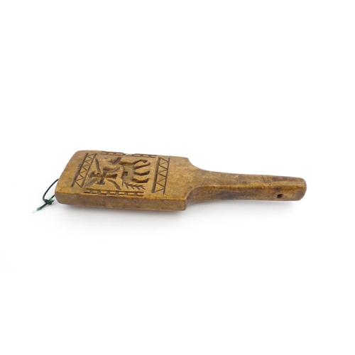 1131 - Treen : A 19thC carved wooden gingerbread biscuit mould of paddle form with horse and cross decorati... 