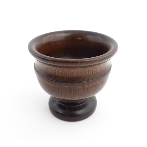 1134 - Treen : An 18th/19thC oak pedestal master salt with banded detail. Approx. 4 1/4