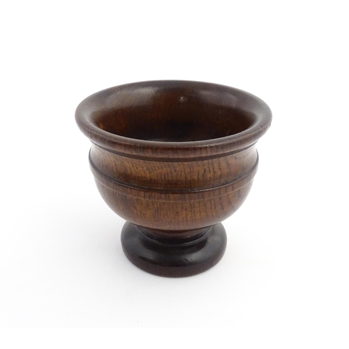 1134 - Treen : An 18th/19thC oak pedestal master salt with banded detail. Approx. 4 1/4