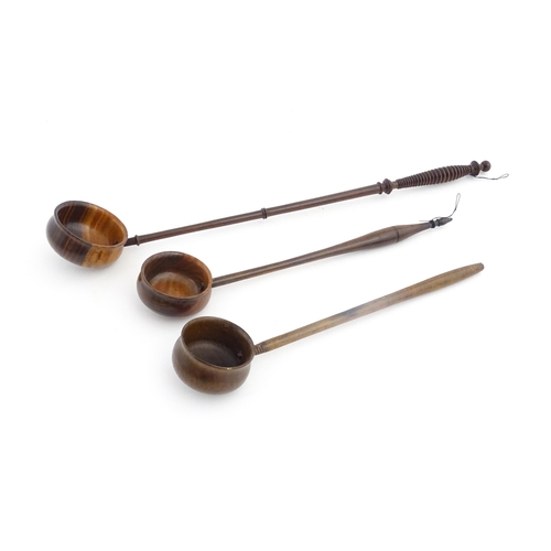 1142 - Treen : Three 18th / 19thC wooden cordial spoons. Largest approx. 17 1/2