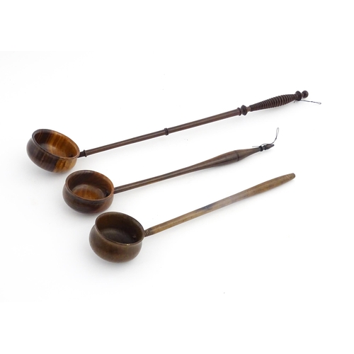 1142 - Treen : Three 18th / 19thC wooden cordial spoons. Largest approx. 17 1/2