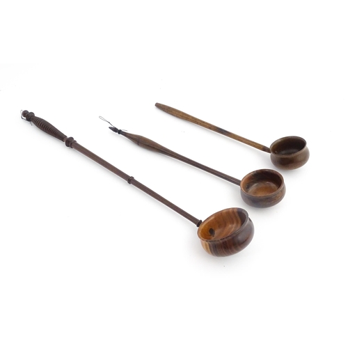 1142 - Treen : Three 18th / 19thC wooden cordial spoons. Largest approx. 17 1/2