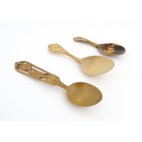 1143 - Treen : Three carved spoons, to include a Scandinavian example, one with carved Asiatic pheasant det... 