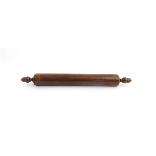 1145 - Treen : A 19thC rolling pin with turned acorn formed handles. Approx. 18