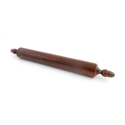 1145 - Treen : A 19thC rolling pin with turned acorn formed handles. Approx. 18