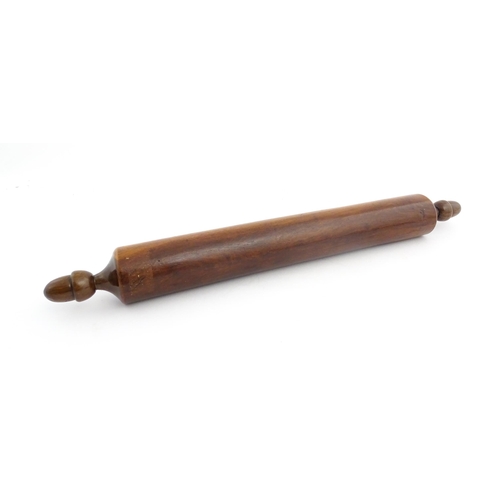 1145 - Treen : A 19thC rolling pin with turned acorn formed handles. Approx. 18