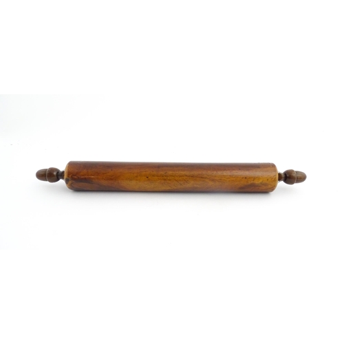 1145 - Treen : A 19thC rolling pin with turned acorn formed handles. Approx. 18