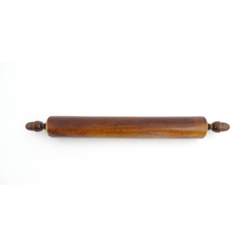 1145 - Treen : A 19thC rolling pin with turned acorn formed handles. Approx. 18