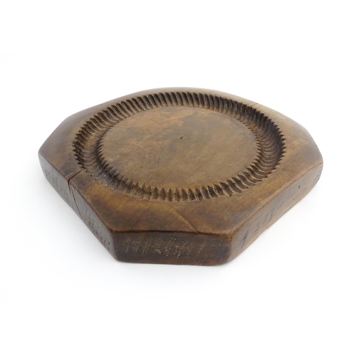 1148 - Treen : A 19thC treen shortbread biscuit mould of octagonal form. Approx. 9 3/4