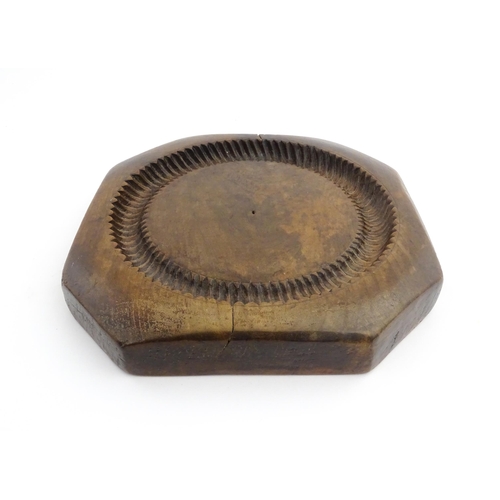 1148 - Treen : A 19thC treen shortbread biscuit mould of octagonal form. Approx. 9 3/4