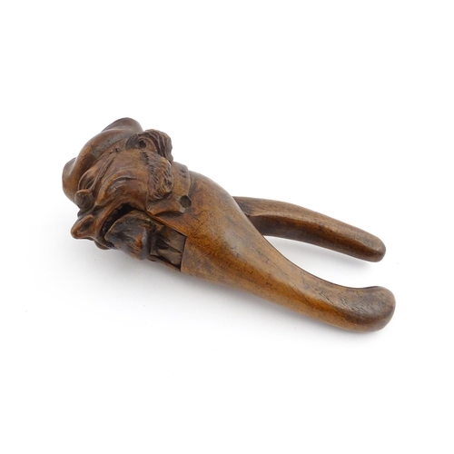 1150 - Treen : A 19thC novelty treen nutcracker modelled as a man wearing a tricorn hat and spectacles. App... 