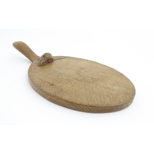 1154 - Treen : An early to mid 20thC Mouseman oak cheese board with carved trademark mouse and adzed detail... 