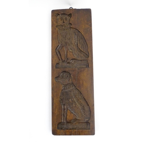 1156 - Treen : A 19thC folk art carved fruitwood gingerbread biscuit / cookie mould depicting a seated cat ... 