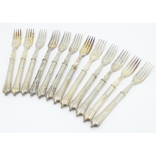 446 - A twelve place set of Victorian silver Albany pattern fish eaters comprising 12 knives and forks hal... 