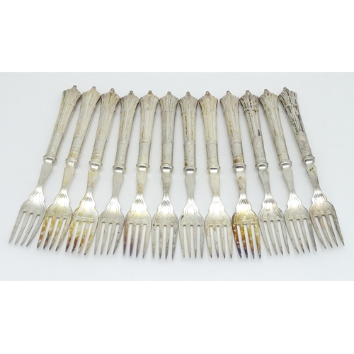 446 - A twelve place set of Victorian silver Albany pattern fish eaters comprising 12 knives and forks hal... 