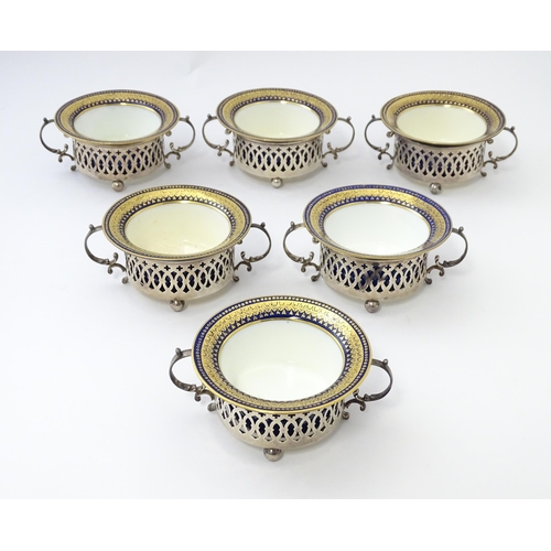 479 - A set of six Canadian silver twin handled cruet / coaster frames with pierced detail, marked under B... 