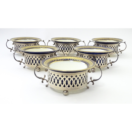 479 - A set of six Canadian silver twin handled cruet / coaster frames with pierced detail, marked under B... 