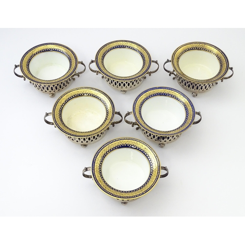 479 - A set of six Canadian silver twin handled cruet / coaster frames with pierced detail, marked under B... 