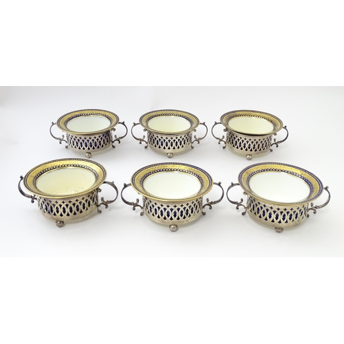 479 - A set of six Canadian silver twin handled cruet / coaster frames with pierced detail, marked under B... 