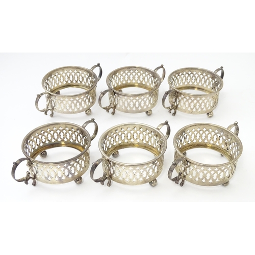 479 - A set of six Canadian silver twin handled cruet / coaster frames with pierced detail, marked under B... 