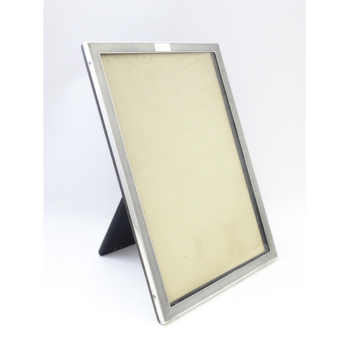 480 - An easel back photograph frame with silver surround hallmarked Birmingham 1936, maker Charles S. Gre... 