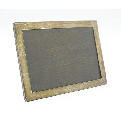 486 - An easel back photograph frame with silver surround hallmarked Birmingham 1924. Together with a phot... 