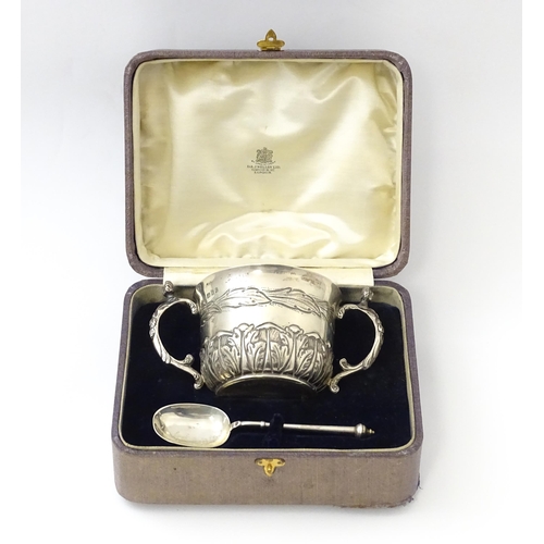 492 - A cased silver Christening set comprising twin handled bowl / porringer and spoon hallmarked London ... 