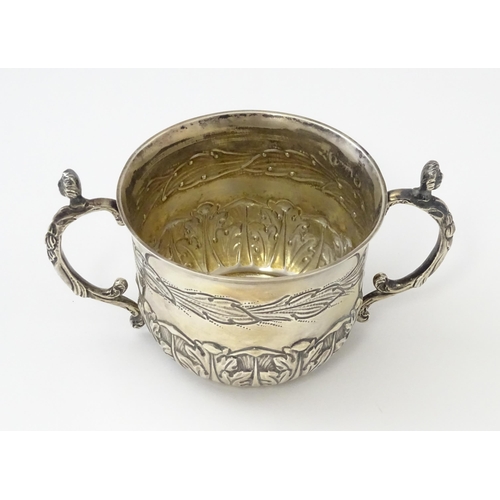 492 - A cased silver Christening set comprising twin handled bowl / porringer and spoon hallmarked London ... 