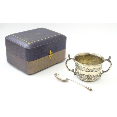 492 - A cased silver Christening set comprising twin handled bowl / porringer and spoon hallmarked London ... 