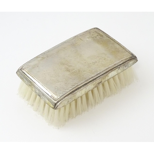 506 - A silver mounted brush with engine turned decoration hallmarked Birmingham 1986, maker Broadway & Co... 