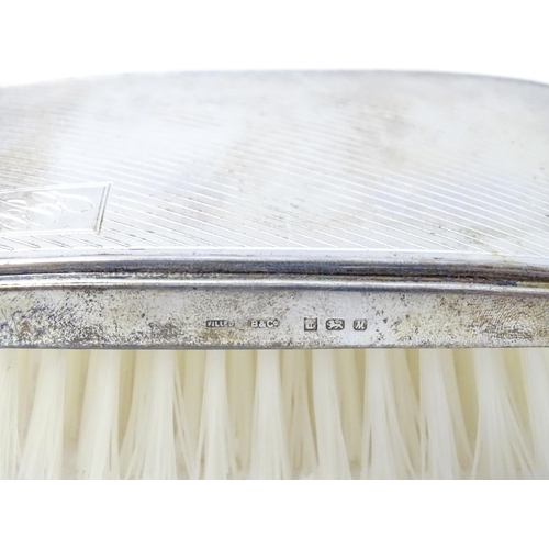 506 - A silver mounted brush with engine turned decoration hallmarked Birmingham 1986, maker Broadway & Co... 