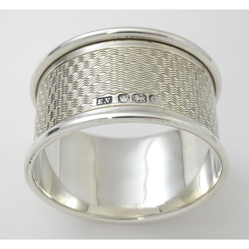 510 - A silver napkin ring with engine turned decoration. Hallmarked Sheffield 1945 maker Viner's Ltd. Cas... 